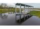 Modern boat lift at a community lake at 5034 Down Ct, St Cloud, FL 34772