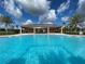 Resort-style pool with a covered patio and palm trees at 5034 Down Ct, St Cloud, FL 34772