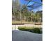 Kidney-shaped pool with screen enclosure needs cleaning at 5427 Los Palma Vista Dr, Orlando, FL 32837