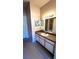 Bathroom vanity with sink and large mirror at 5979 Westgate Dr # 1021, Orlando, FL 32835