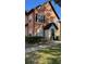 Two-story townhome with light orange exterior and landscaping at 5979 Westgate Dr # 1021, Orlando, FL 32835
