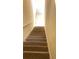 Indoor staircase with carpeted steps and neutral-colored walls at 5979 Westgate Dr # 1021, Orlando, FL 32835