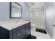 Modern bathroom featuring a walk-in shower, updated vanity, and elegant gray and white finishes at 657 Hunters Run Blvd, Lakeland, FL 33809