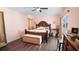 Cozy bedroom featuring a wood-trimmed bed, a ceiling fan, and a sliding glass door at 657 Hunters Run Blvd, Lakeland, FL 33809