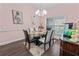 Elegant dining room showcasing a modern chandelier, dining table and a stylish fish tank at 657 Hunters Run Blvd, Lakeland, FL 33809