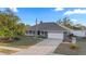 Inviting single Gathering home featuring a well manicured lawn, lush landscaping and a long driveway at 657 Hunters Run Blvd, Lakeland, FL 33809