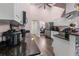 Bright kitchen featuring white cabinets, dark countertops, and a breakfast bar that seats three at 657 Hunters Run Blvd, Lakeland, FL 33809