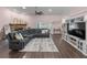 Cozy living room featuring dark wood floors, a fireplace, ceiling fan and a plush L shaped sofa at 657 Hunters Run Blvd, Lakeland, FL 33809