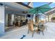 Inviting patio space with comfortable seating, a dining table, and an outdoor kitchen area at 657 Hunters Run Blvd, Lakeland, FL 33809
