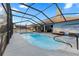 A screened-in pool features an outdoor dining area with a table, chairs, and lounge seating at 657 Hunters Run Blvd, Lakeland, FL 33809