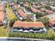 Aerial view of townhouses with swimming pools and lush landscaping at 8519 Bay Lilly Loop, Kissimmee, FL 34747