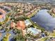Aerial view of community with pool and lake at 8519 Bay Lilly Loop, Kissimmee, FL 34747