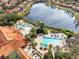 Large community pool, clubhouse, and lake view at 8519 Bay Lilly Loop, Kissimmee, FL 34747