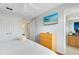 Bedroom with a dresser, TV, and en-suite bathroom at 8519 Bay Lilly Loop, Kissimmee, FL 34747