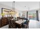 Dining area with a glass top table and six chairs, overlooking the pool at 8519 Bay Lilly Loop, Kissimmee, FL 34747