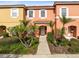 Two-story townhome with front yard landscaping and walkway at 8519 Bay Lilly Loop, Kissimmee, FL 34747