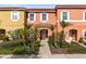 Two-story townhome with front yard landscaping and walkway at 8519 Bay Lilly Loop, Kissimmee, FL 34747