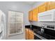 Kitchen with wood cabinets, granite counters, and appliances at 8519 Bay Lilly Loop, Kissimmee, FL 34747
