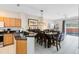 Open kitchen with granite counters, wood cabinets, and breakfast bar at 8519 Bay Lilly Loop, Kissimmee, FL 34747