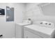 Laundry room with washer, dryer, and shelving at 8519 Bay Lilly Loop, Kissimmee, FL 34747
