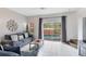 Living room with sliding doors leading to a private pool at 8519 Bay Lilly Loop, Kissimmee, FL 34747