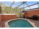 Relaxing screened pool and patio with grill and seating area at 8519 Bay Lilly Loop, Kissimmee, FL 34747