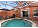Private screened pool and patio area, with grill, chairs and umbrella at 8519 Bay Lilly Loop, Kissimmee, FL 34747