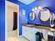 Bathroom with double vanity, granite countertop, and blue walls at 925 Wintergreen Blvd, Fern Park, FL 32730