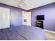Purple bedroom with double bed, ceiling fan, and wood-look floors at 925 Wintergreen Blvd, Fern Park, FL 32730