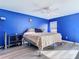 Blue bedroom with a queen bed, ceiling fan, and laminate flooring at 925 Wintergreen Blvd, Fern Park, FL 32730