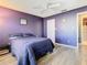 Purple bedroom with double bed, ceiling fan, and wood-look floors at 925 Wintergreen Blvd, Fern Park, FL 32730
