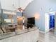 Living area with sectional sofa, high ceiling, and view into dining area at 925 Wintergreen Blvd, Fern Park, FL 32730
