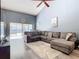 Living room features L-shaped sectional sofa and sliding glass doors at 925 Wintergreen Blvd, Fern Park, FL 32730