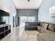 Living room with L-shaped sectional sofa and view to backyard patio at 925 Wintergreen Blvd, Fern Park, FL 32730