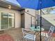 Relaxing patio with table, chairs, umbrella, and access to interior at 925 Wintergreen Blvd, Fern Park, FL 32730