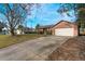 Charming single story brick home featuring a two car garage, manicured lawn and extended driveway at 935 Prescott Blvd, Deltona, FL 32738