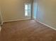 Bedroom with neutral walls, carpet flooring and sliding glass door at 9714 Nonacrest Dr, Orlando, FL 32832