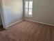 Bedroom with neutral walls, carpet flooring and a window with shutters at 9714 Nonacrest Dr, Orlando, FL 32832