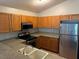 Kitchen with wood cabinets, stainless steel appliances and double sink at 9714 Nonacrest Dr, Orlando, FL 32832