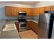 Kitchen with wood cabinets, stainless steel appliances and double sink at 9714 Nonacrest Dr, Orlando, FL 32832
