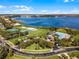 An aerial view of a community with a lake, pool, sports courts and residential neighborhood at 1101 Maidenmoor Rd, Winter Garden, FL 34787