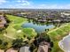 Aerial view featuring the golf course with a water feature and homes in the background at 1101 Maidenmoor Rd, Winter Garden, FL 34787