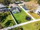 Aerial view shows a backyard with a screened pool, lush lawn, and trampoline, enclosed by a white picket fence at 1101 Maidenmoor Rd, Winter Garden, FL 34787