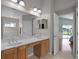 A double vanity is featured in this bathroom, with a view toward the pool at 1101 Maidenmoor Rd, Winter Garden, FL 34787