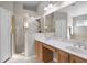 A double vanity and glass enclosed shower are featured in this bathroom at 1101 Maidenmoor Rd, Winter Garden, FL 34787
