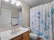 This cozy bathroom has a single vanity and shower with a decorative curtain at 1101 Maidenmoor Rd, Winter Garden, FL 34787