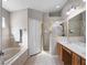 Bright bathroom featuring a double vanity, soaking tub and glass enclosed shower at 1101 Maidenmoor Rd, Winter Garden, FL 34787