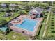 Aerial view of community pool area with lounge chairs, playground and two-story recreation center at 1101 Maidenmoor Rd, Winter Garden, FL 34787