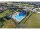 Community pool with lounge chairs, playground, splash pad, and lake view from an aerial perspective at 1101 Maidenmoor Rd, Winter Garden, FL 34787