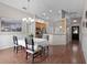 Open-concept dining area seamlessly connects to a kitchen with wood cabinets and stainless steel appliances at 1101 Maidenmoor Rd, Winter Garden, FL 34787